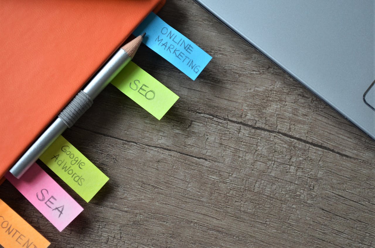 discover Close-up of SEO strategy planner with colorful sticky notes and a pencil on a notebook.